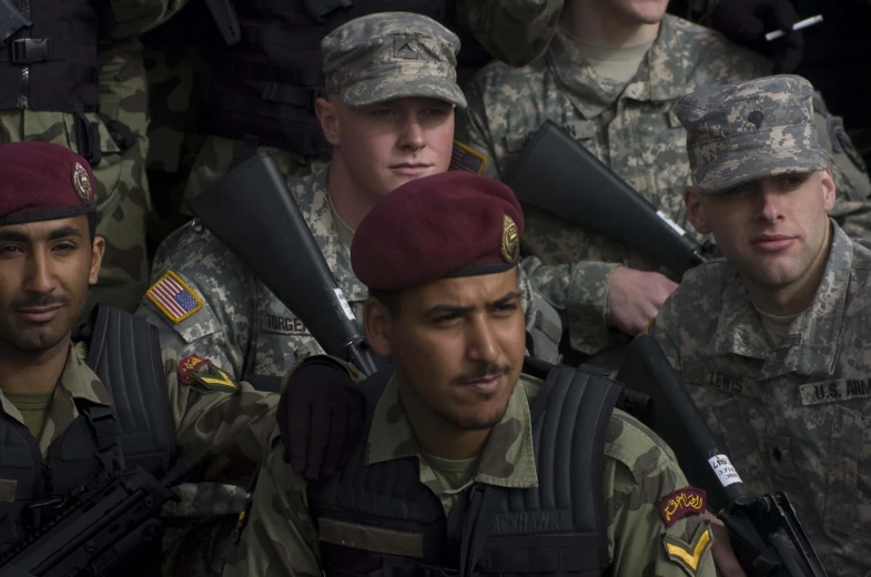 group of soldiers dressed in uniform and holding guns