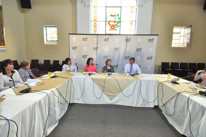 people sitting in front of an empty white table