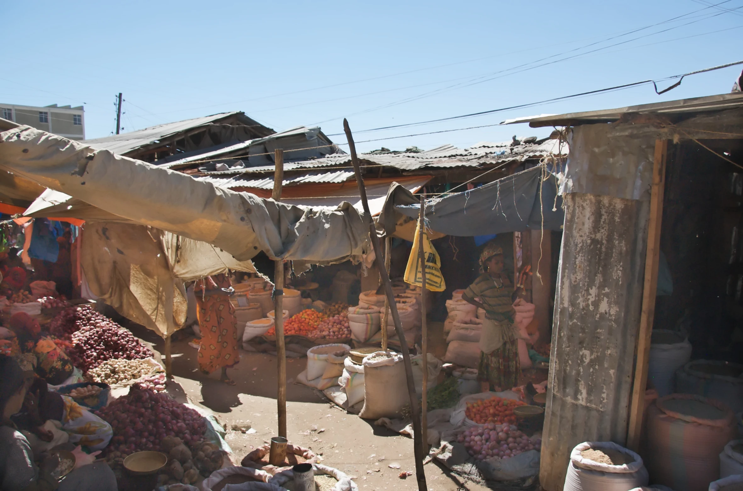 the people are working at the market selling goods