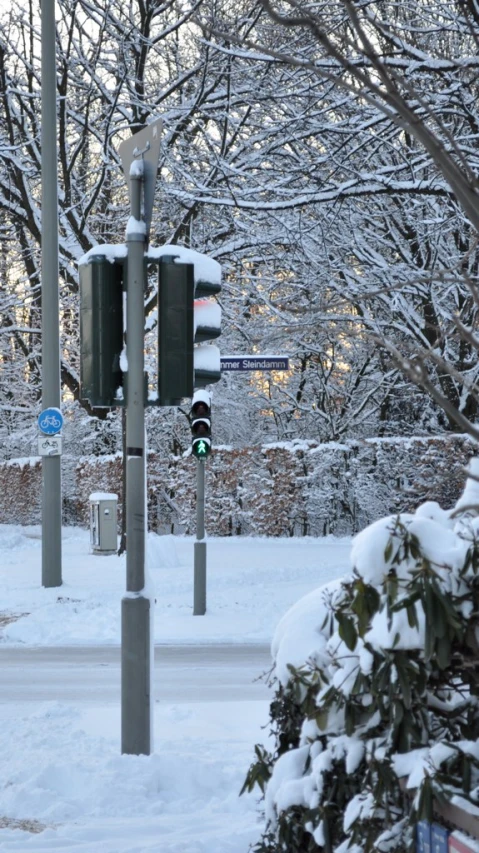 a snowy road and street with traffic lights