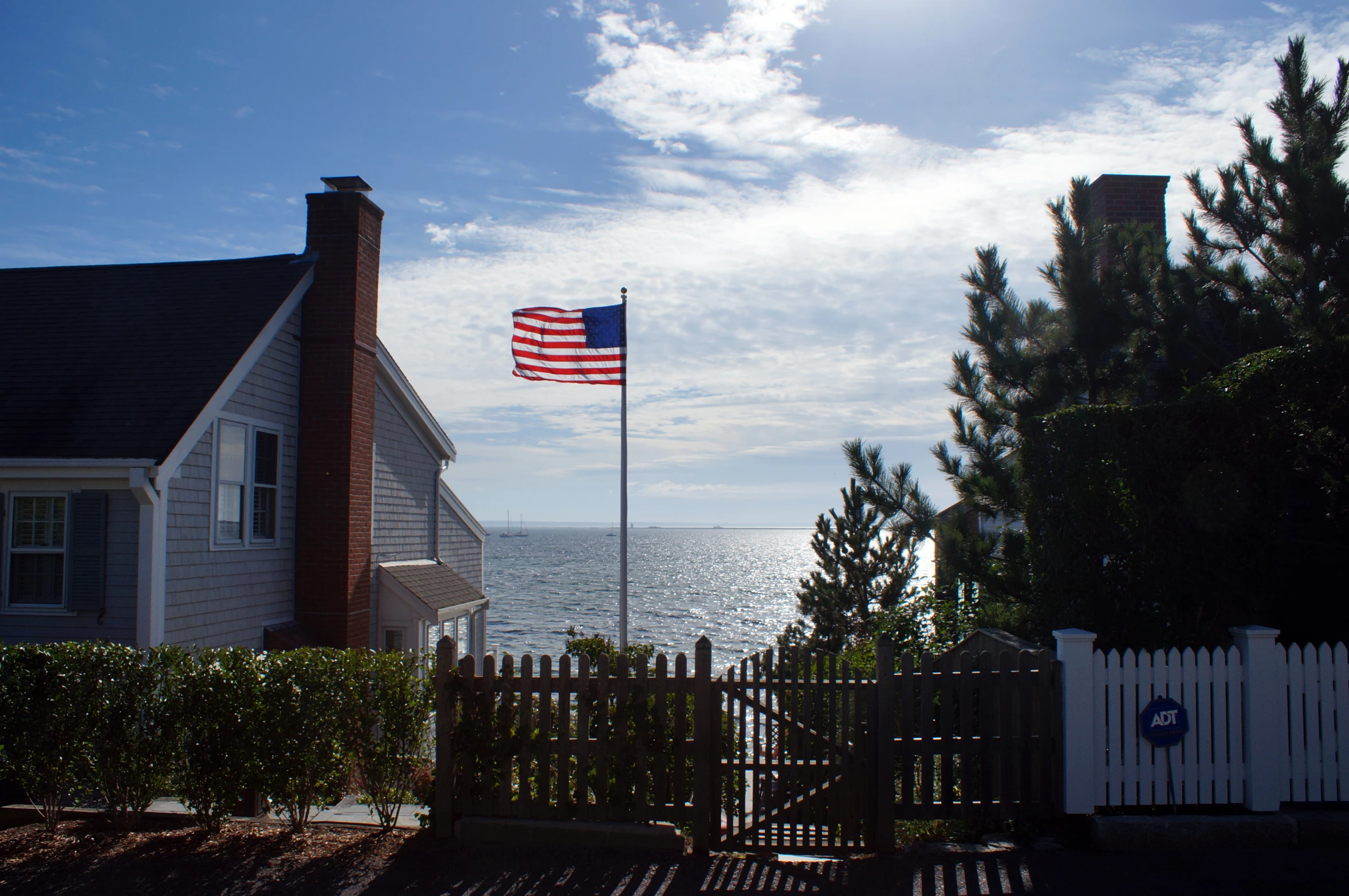 a flag flies from the beach side on an overcast day