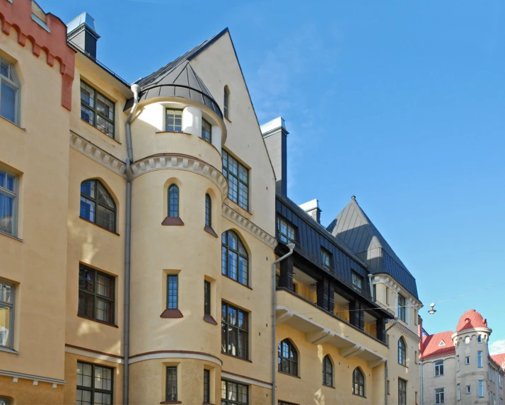 a building with many windows and red roofs