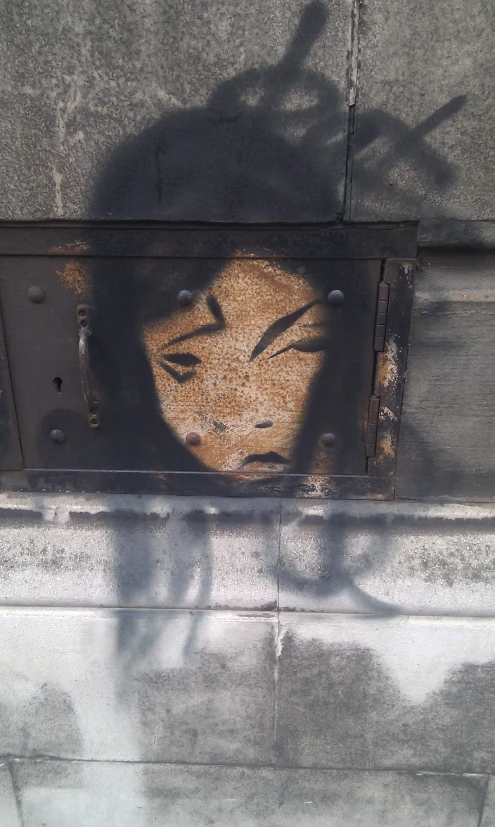 a street scene with a face drawn on a wall