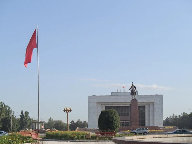 a large building with a flag flying in front