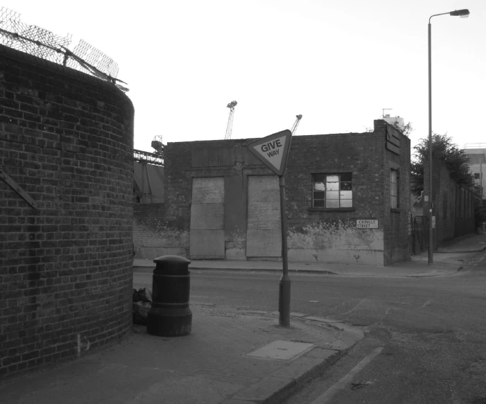 an old, run down street corner with graffiti on buildings