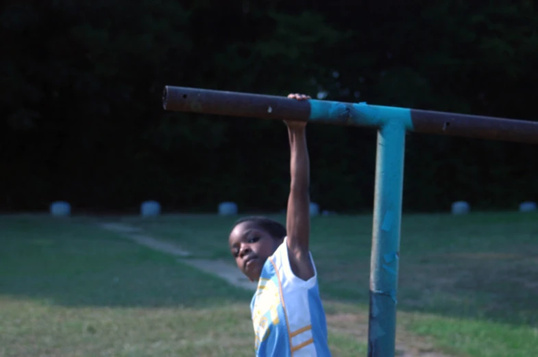 the girl is playing volleyball on the field