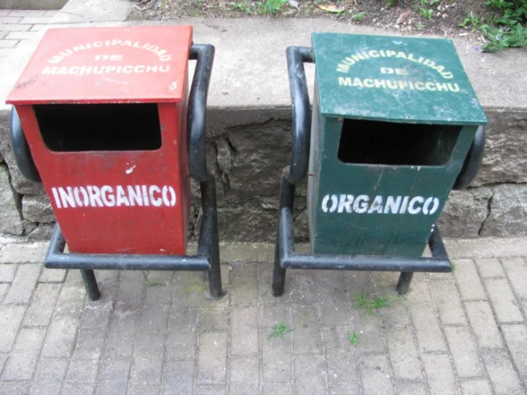 two garbage cans with an inner bin next to one on the sidewalk