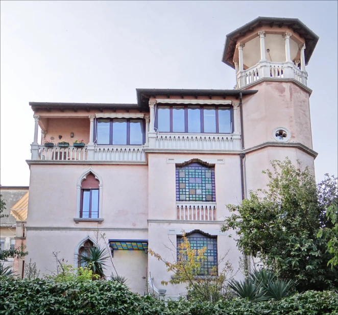 a house with a clock tower sitting on top of it's side