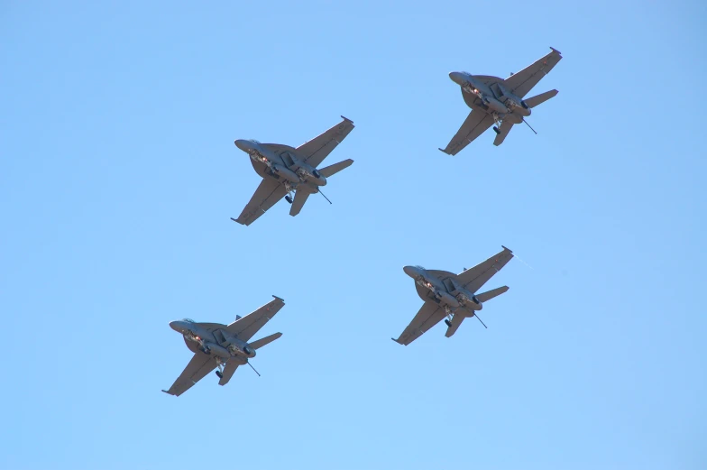 four planes are flying in formation in the air