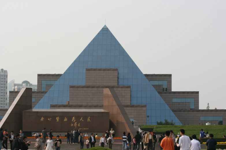 people walking around in front of a museum