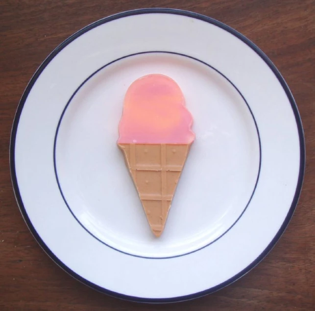 the white plate with a piece of ice cream and pink gelato on it