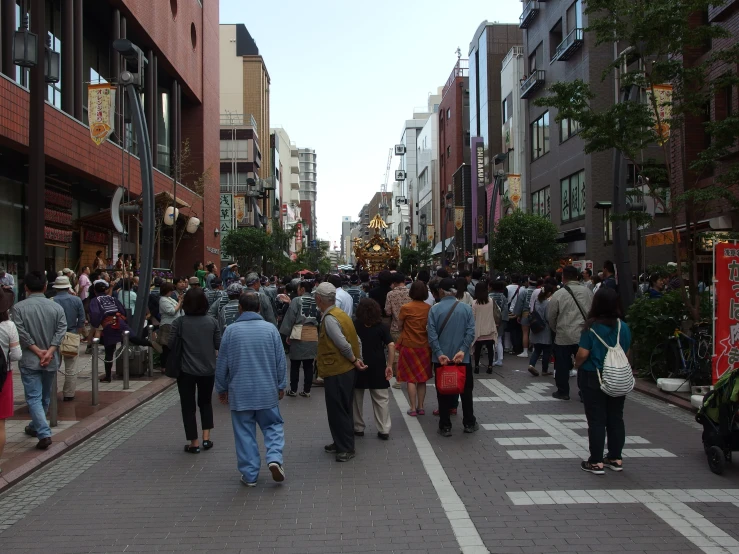 many people are walking down the street together