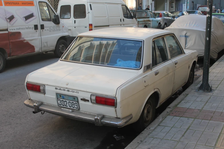 a white car parked on a side walk