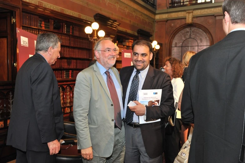 some men are having a conversation at an event