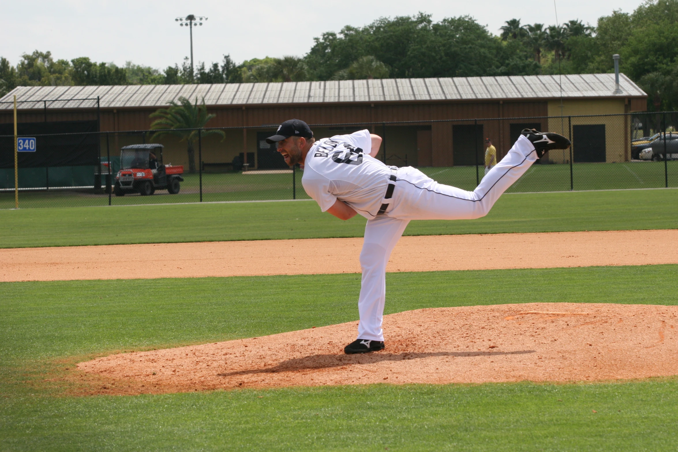 baseball pitcher in uniform pitching a ball during a game