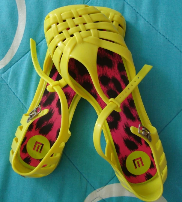 a pair of pink and yellow patterned sandal