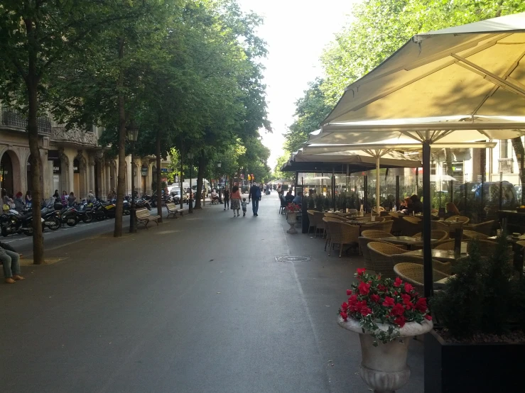 there are several tables and chairs lining the street