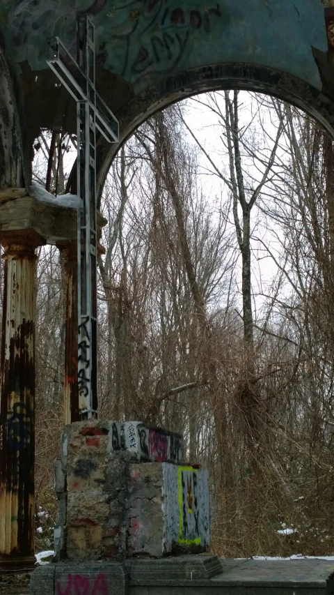 graffiti and paint cover the top of an old structure