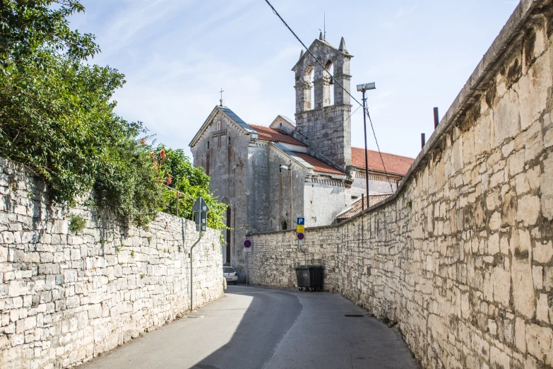 an empty alley between two old stone buildings