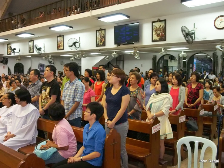 the people are standing in a church waiting for their turn