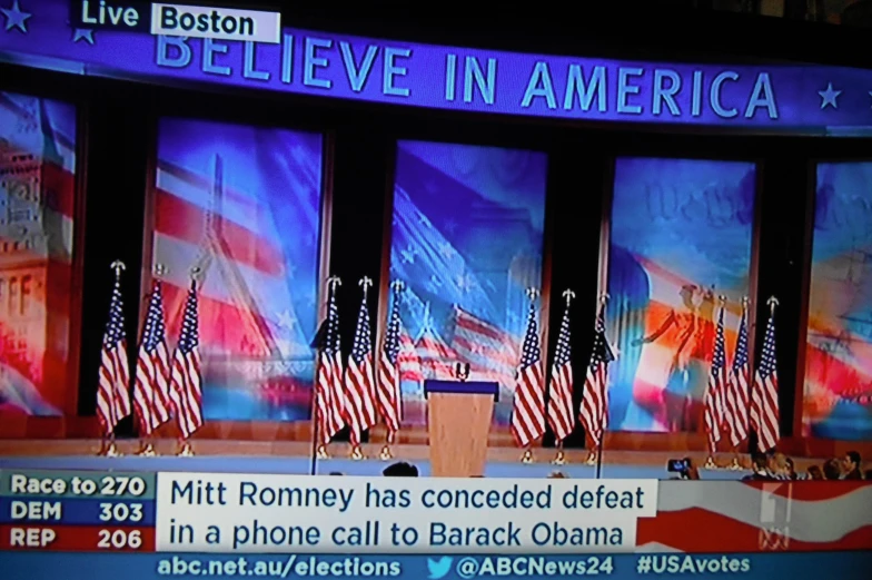 a debate stage decorated with american flags and signs