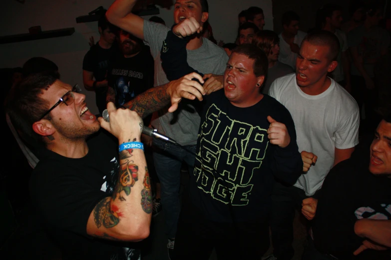 group of men drinking beer and laughing while having party