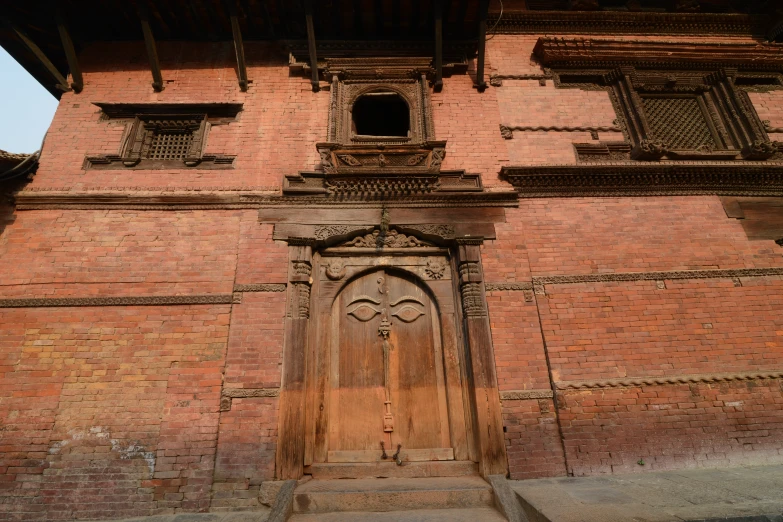 an old brick building with some very wooden doors