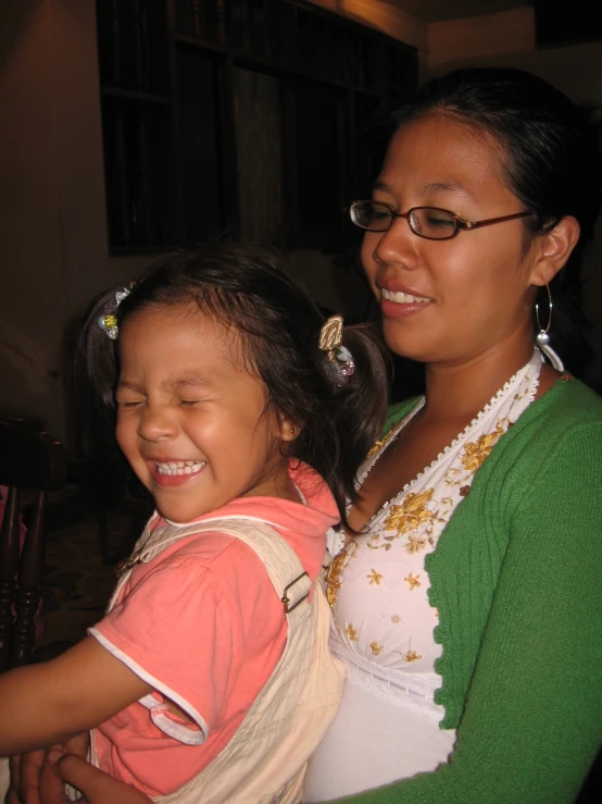 a woman holding a child up to their neck