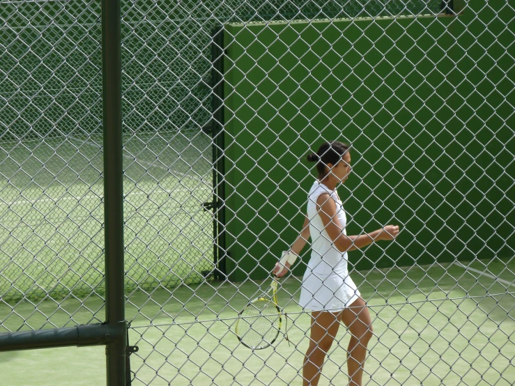 a woman on a tennis court holding a tennis racket