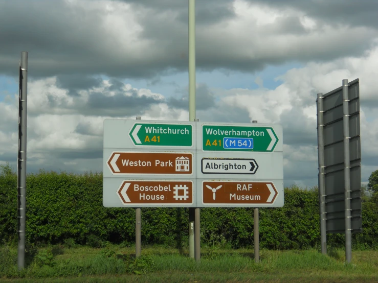 two directional signs giving directions on a rural road