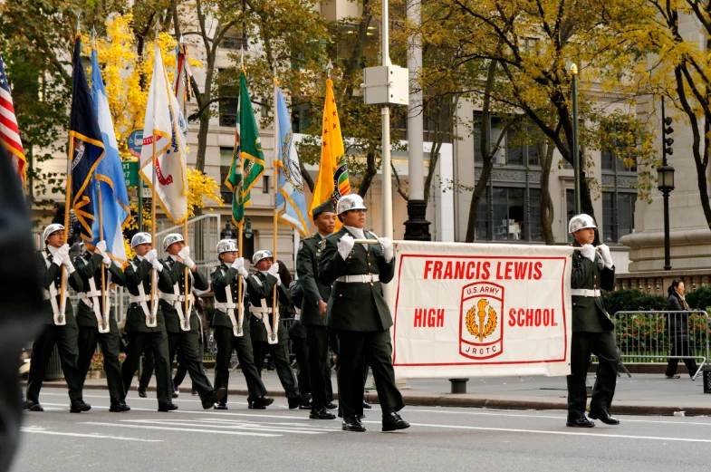 an army marches in formation with flags, banners and a sign