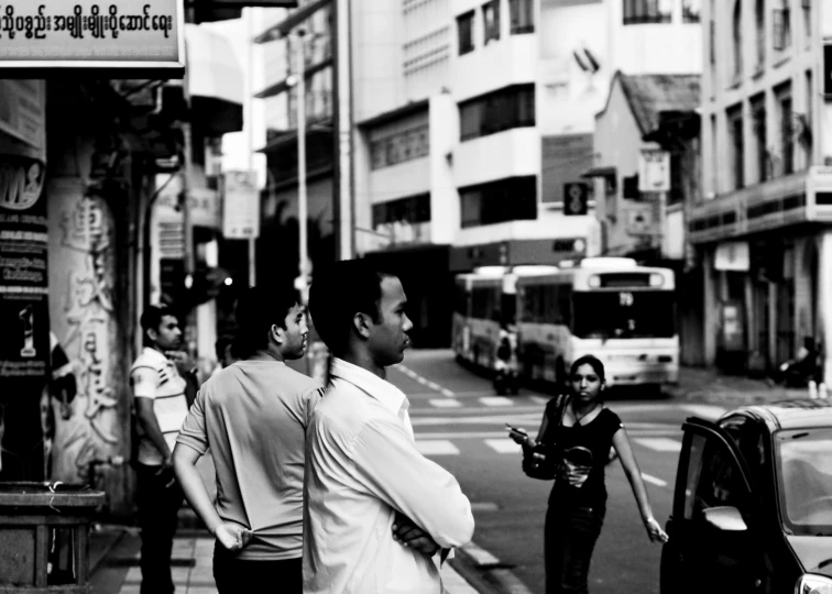 people on a sidewalk in the city at night