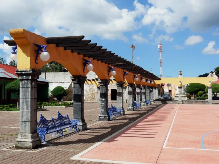 rows of benches line the outdoor basketball court