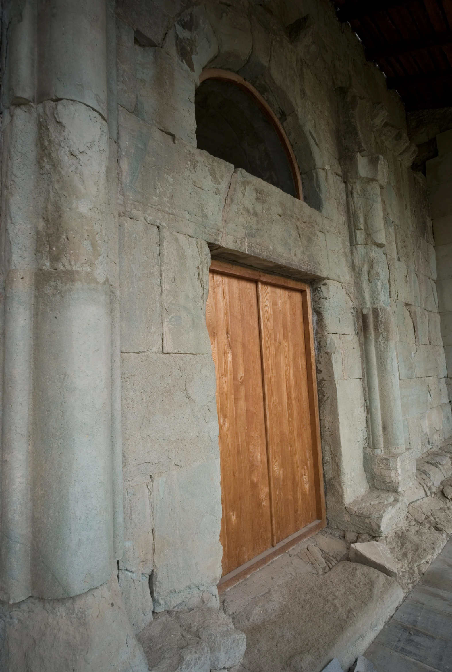 an old stone building with an arched wooden door