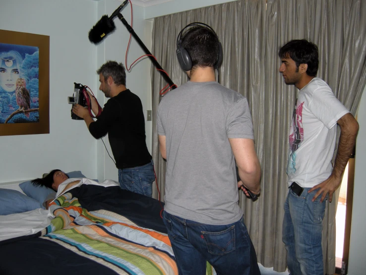 three people who are standing in a room playing with soing