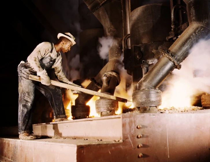 a person working in a large metal plant