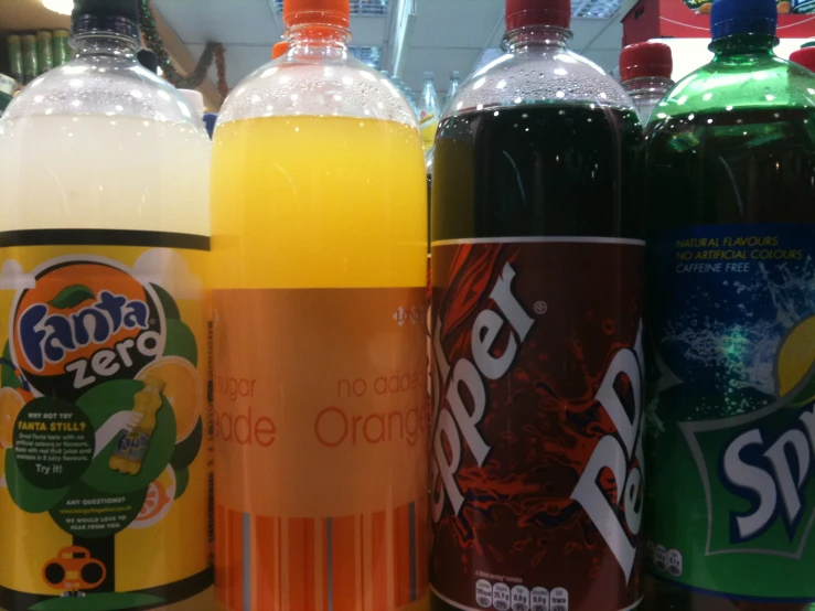 several drinks in bottles on a rack of shelf