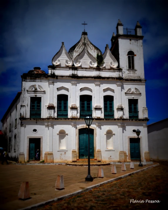 the architecture on a building is white and there are no doors