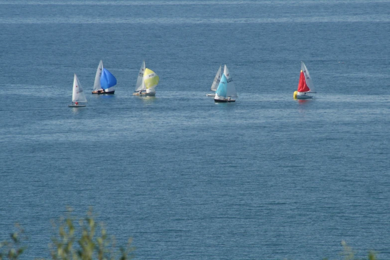 a group of boats floating on top of the ocean