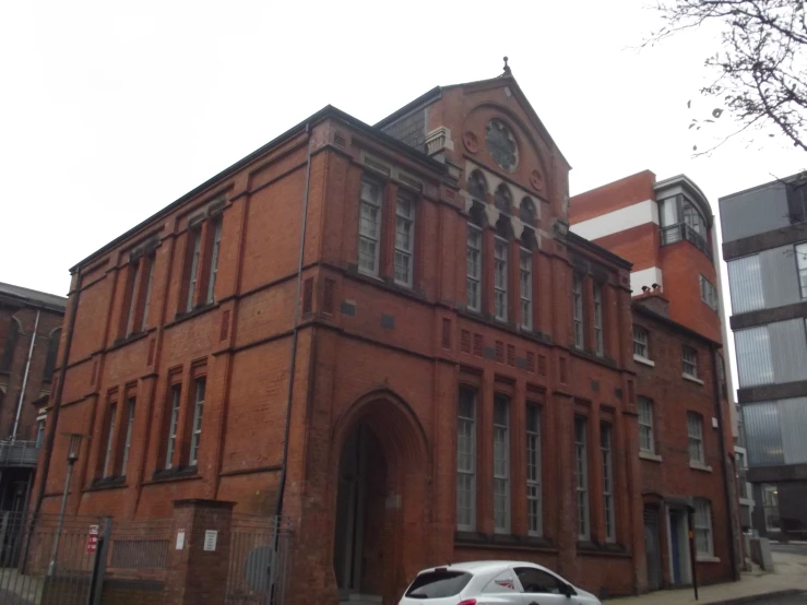 a car is parked in front of a brick building