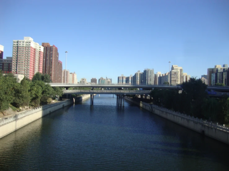 a long bridge with some buildings on the other side