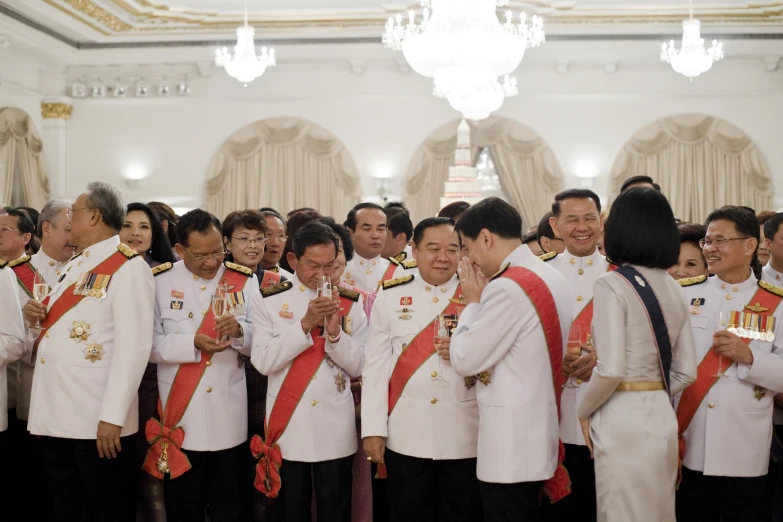 a group of people in uniform are holding hands together