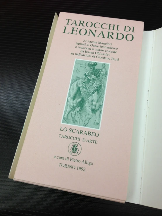 a pink book with green ink laying open