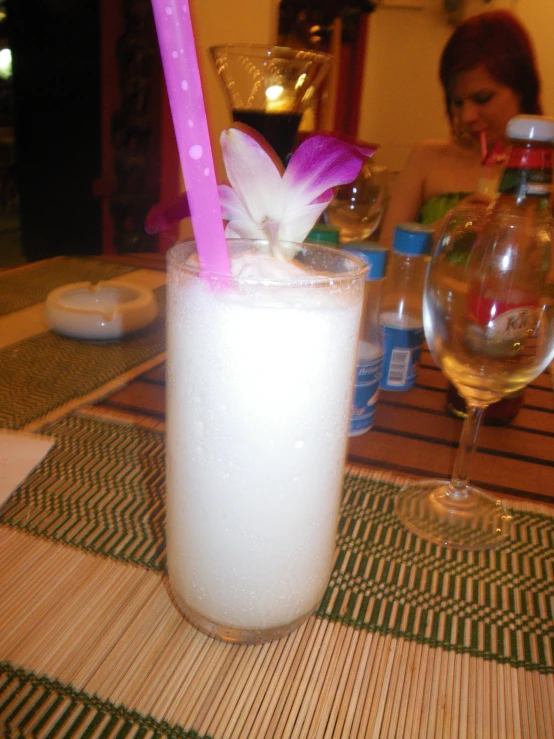 a pink and white drink on a wooden table