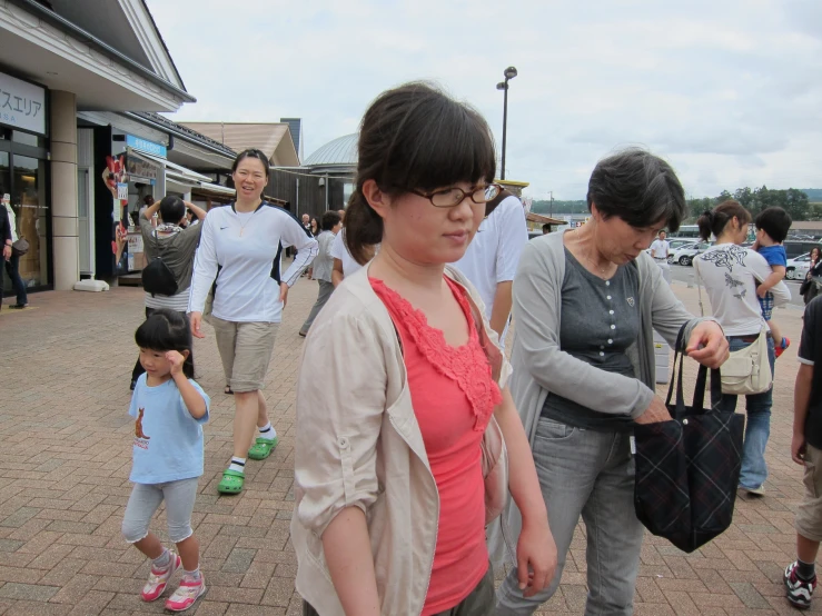 a girl and two women walking along the street