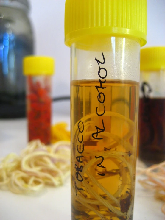 a bottle sitting on top of a table filled with pasta