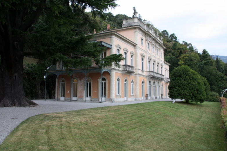 a house with a lawn and trees in front