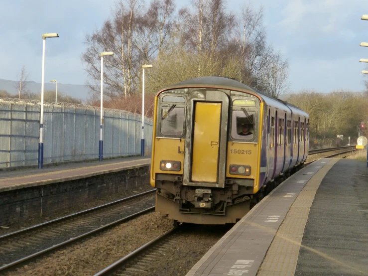 the train is passing under the bridge over the tracks