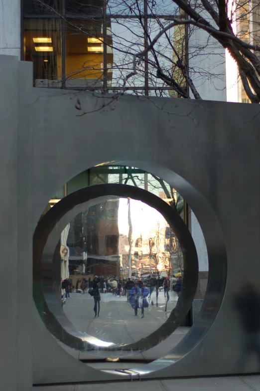 a circular sculpture with people walking around