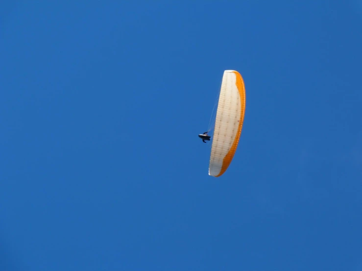 a para - sailer in a blue sky at sunrise